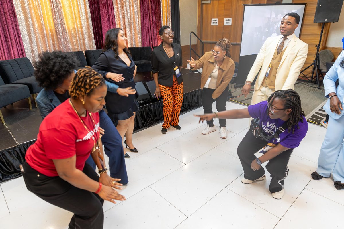 Attendees dancing in a circle on the dance floor at EventPro Connect 2.0